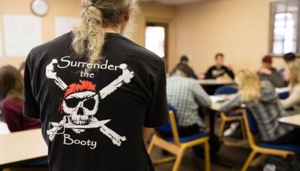 Phil Kozel, associate professor of economics, leads his Mysteries and Marvels of Piracy class in a study of the economics and politics on ship. (Photo by Scott Cook)